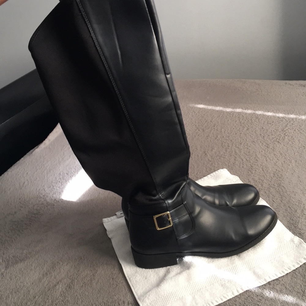 Black riding boots with gold hardware
